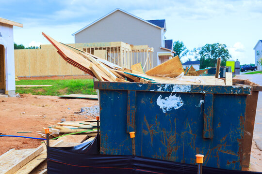 Workers are clearing waste materials from construction area where new homes are being built.