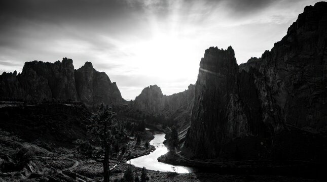 Black and white landscape of mountains and river.