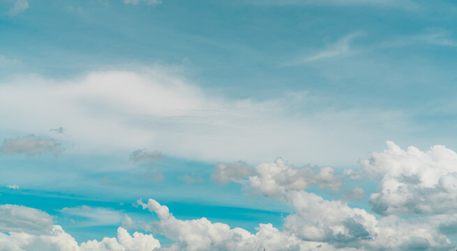Cloudscape of white stratocumulus clouds on blue sky. Full Frame of white fluffy clouds texture background. Heaven sky with daylight. Beauty in nature. Summer sky. Pure white clouds. Freedom concept.