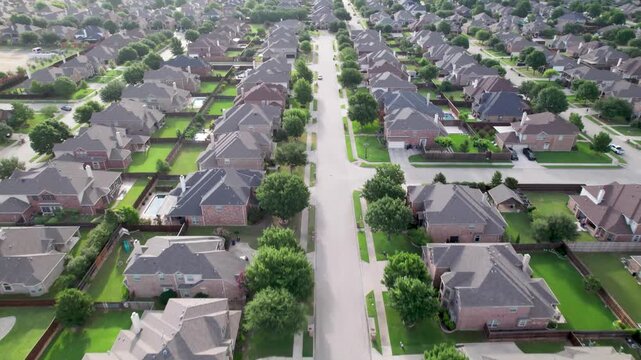 Aerial video of a neighborhood in Frisco Texas, flying over Holly Tree Ln.