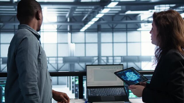 Computer scientists manage predictive maintenance in a server room with laptop and tablet, combining computing processes, IT team and infrastructure review.