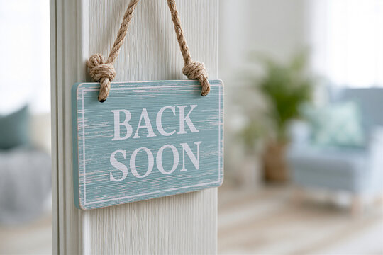 Hanging wooden BACK SOON sign indicating a temporary absence