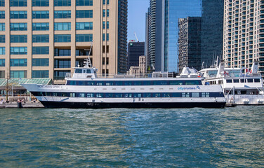 Obraz premium TORONTO, ONTARIO, CANADA - 30 MAY 2026: Toronto Embankment. Northern Spirit I cruise boat operated by City Cruises docked at Harbourfront waterfront in downtown Toronto