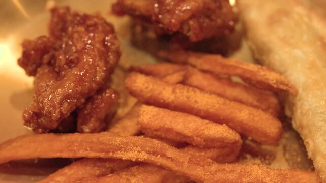 Korean Fried Chicken and Seasoned French Fries on Brass Plate