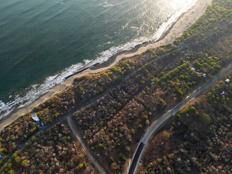 Coastline road at sunset light above top view