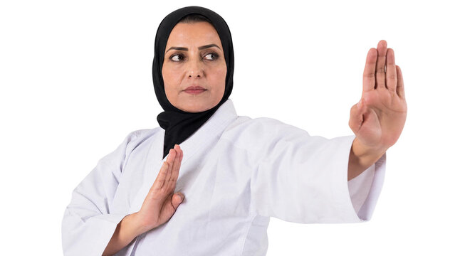 Determined Mature Muslim Woman in Hijab Practicing Karate Martial Arts Pose Isolated on Transparent Background
