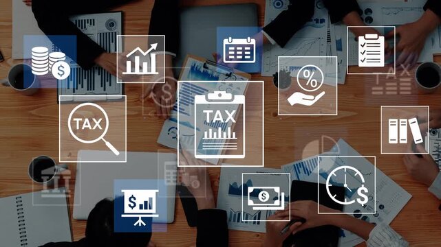 Overhead View of Business Professionals Analyzing Financial Data with Tax Icons and Charts on a Wooden Table During a Collaborative Meeting. Entropy.
