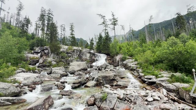 Hrebienok Waterfall in High Tatras Slovakia

Crystal-clear mountain waterfall flowing over granite boulders in Hrebienok, 
surrounded by alpine forest beneath the High Tatras, Slovakia, 20 July 2026.
