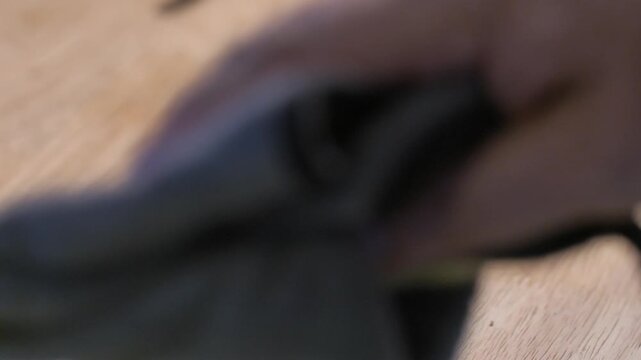 4K video of cleaning a guitar fretboard with a microfiber cloth. For guitar maintenance, instrument care, cleaning, and music equipment concepts