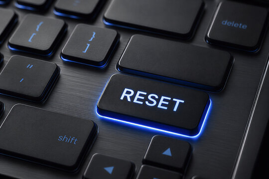 Reset button on computer keyboard with system recovery and restart concept