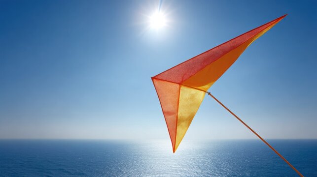 Vibrant parafoil kite soaring high above the ocean under a bright sunny sky, representing the spirit of summer adventure.