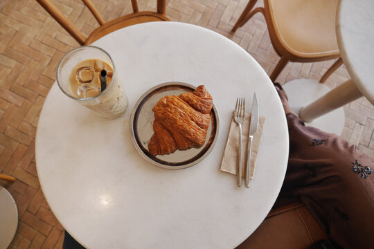 Croissant and drink on a table in a cafe