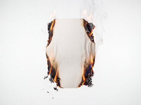 Burning blank white sheet of paper with open fire and smoke on white background