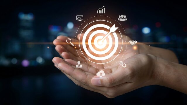 A target with an arrow in the center, hovering above open hands, surrounded by digital icons representing business and success. This image symbolizes achievement, goals.