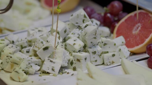 Cheese platter preparation in a kitchen