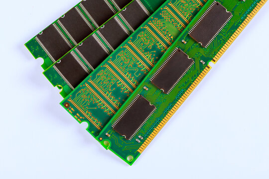Memory chips are placed in rows on green circuit board surfaces with intricate electronic patterns,