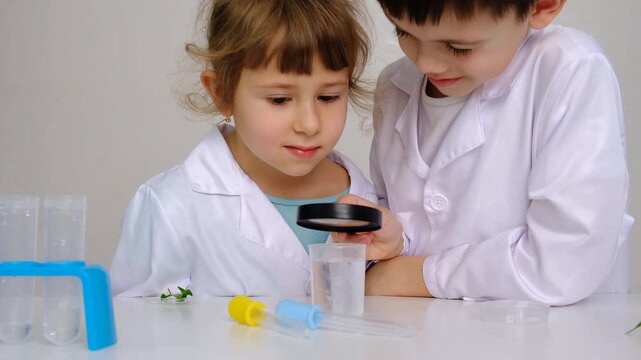 Laboratory examination of a child with test tubes, reagents and a microscope. Selective focus.