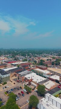 Vertical aerial shot overlooking the historic downtown district of Fond du Lac, Wisconsin, featuring urban architecture and local streets.