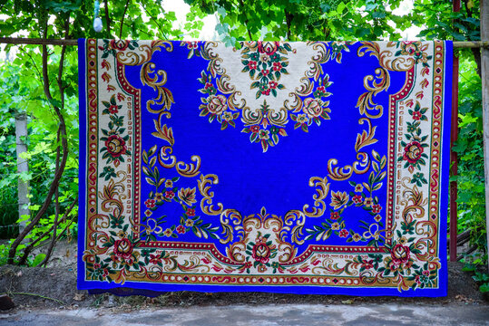 Close-up of a Turquoise Ethnic Handmade Carpet Hanging under a Grape Trellis in Turpan, Xinjiang, China