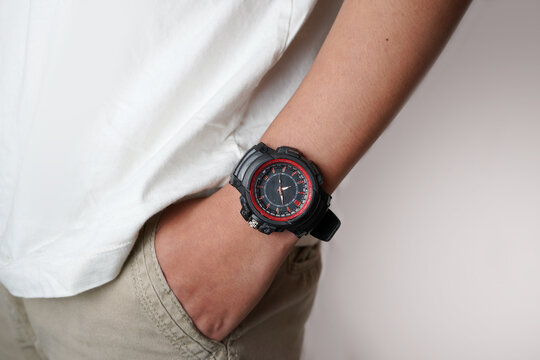 Man wearing rugged wristwatch with hand in pocket