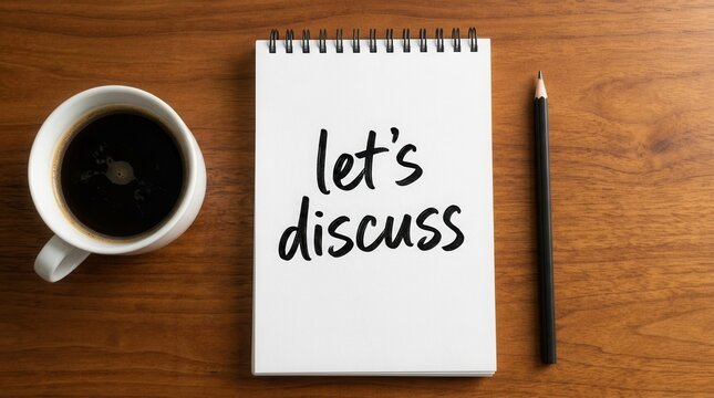 Idea sharing concept featuring a notebook with lets discuss text, coffee cup, and pencil on a wood table.