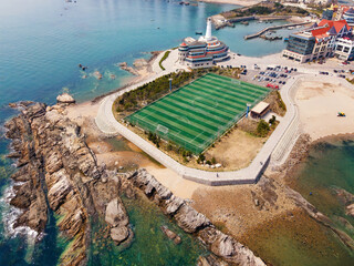Fototapeta premium Aerial View of Coastal Football Field and Buildings