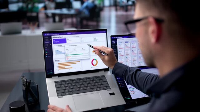 Compliance Officer Reviews AML Software Dashboard On Laptop