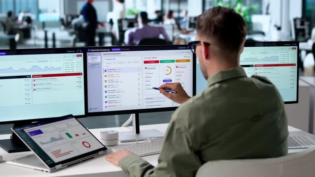 Compliance Officer Monitors Real-time Transactions On Laptop