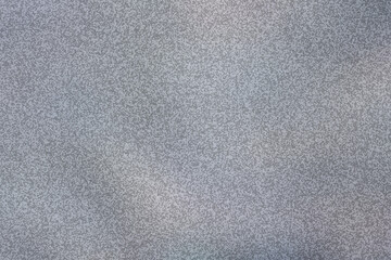 Fototapeta premium Grey grainy abstract background. Minimalist textured surface with soft noise and gradient.