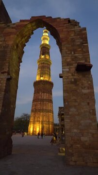 SUNSET BETWEEN ARCHES THE QUTAB MINAR IN DELHI