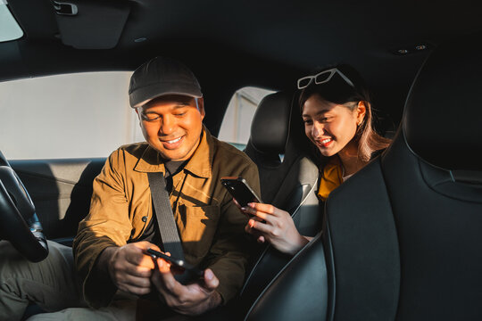 Young asian woman traveler Pay the fare after arriving destination by scan payment qr code with cell phone. Taxi driver finish the job Drop off passengers. Application driver service