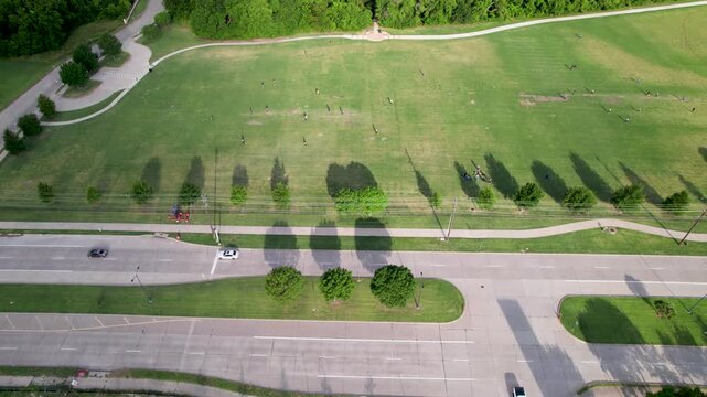 Aerial footage from a far distance of people playing cricket in Frisco Texas