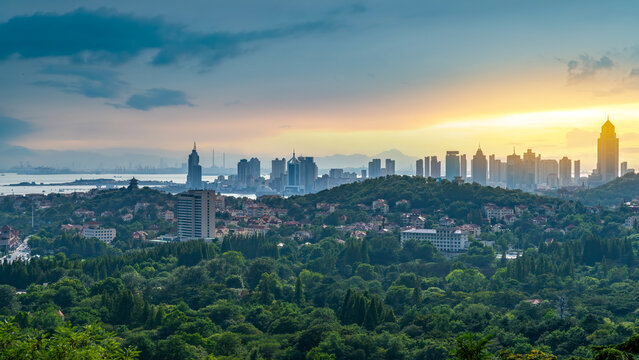 City Skyline Over Green Hills at Sunrise or Sunset