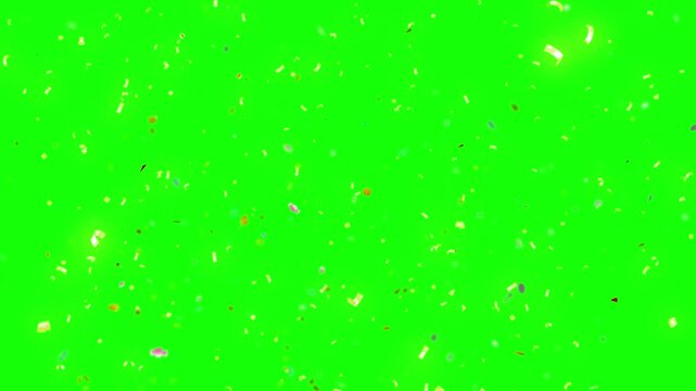 Confetti golden specks rain down slowly against a solid green screen backdrop to allow for seamless video editing and effects.