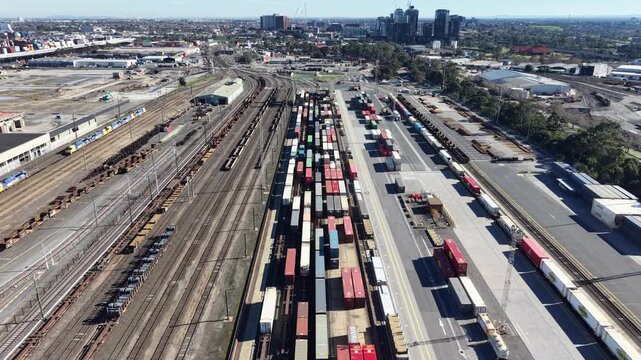 Aerial freight train with shipping containers leaving a railway yard