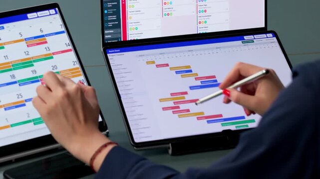 Agile Manager Reviews Project Tasks On Dual Screens