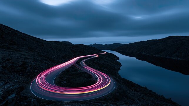 Long Exposure Night Road with Light Trails Beside a Calm River.