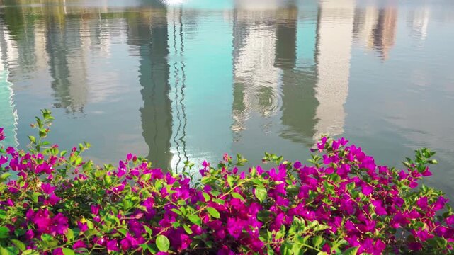 Reflection of Modern Office Building Skyscrapers on Rippled Lake Surface in Bangkok Thailand
