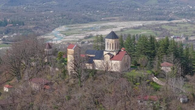 Telephoto drone footage showcasing Martvili Monastery, framed by a winding river valley and the beautiful countryside of western Georgia.