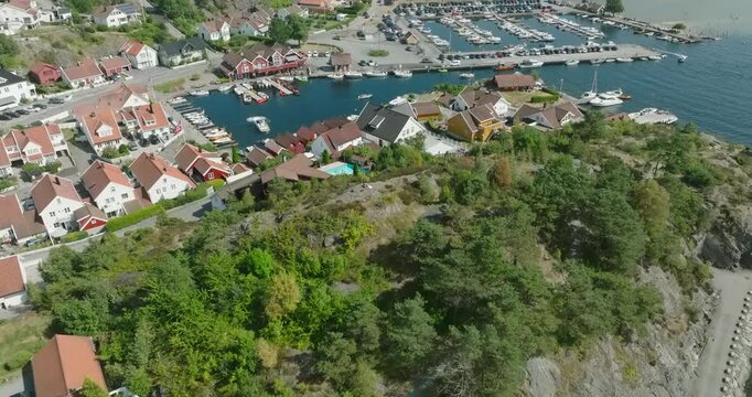 Aerial view of coastal marina and residential area in H&oslash;llen Norway in slow motion