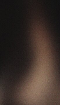Dark moody grainy background featuring subtle bronze light leak and heavy photographic noise for cinematic visual design concepts.