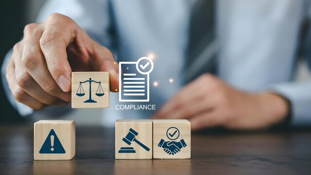 Businessman holding a wooden block with a scale icon, representing legal compliance, regulatory standards, and corporate governance in a business environment