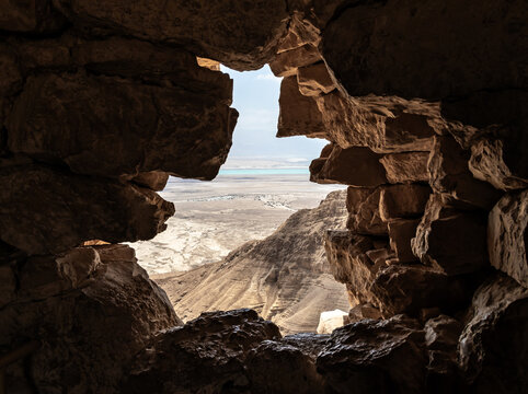 A view  from breach in wall in the ruins of the Mossad fortress of the adjacent plain and the Dead Sea in southern Israel near Arad