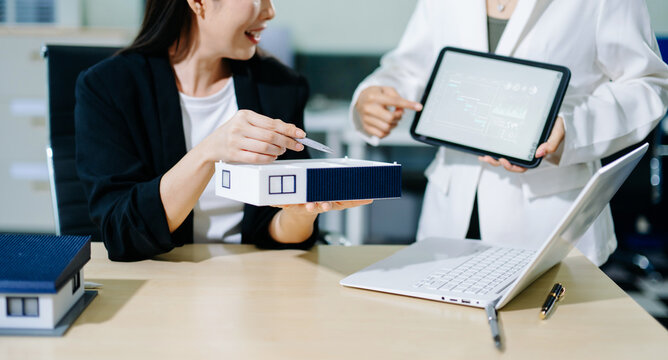 Salesman Hands On House Model , Small Toy House Small Mortgage Property insurance and concepts real estate.	 in office