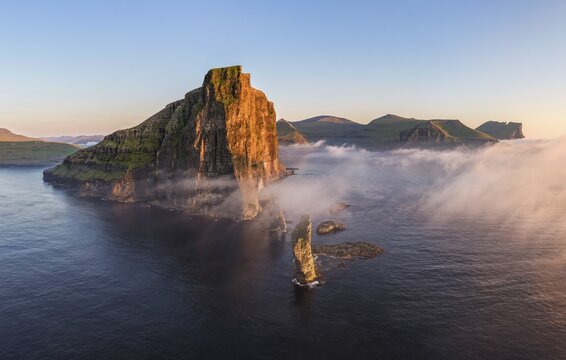 The Risin og Kellingin pinnacles off the Eysturoy cliffs in the evening light, Faroe Islands, Denmark