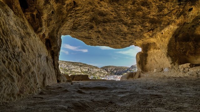 Sky changed, Neolithic caves, former hippie paradise, view from a reddish brown cave of the surrounding landscape and clear sky, Matala, south coast, Crete, Greek islands, Greece