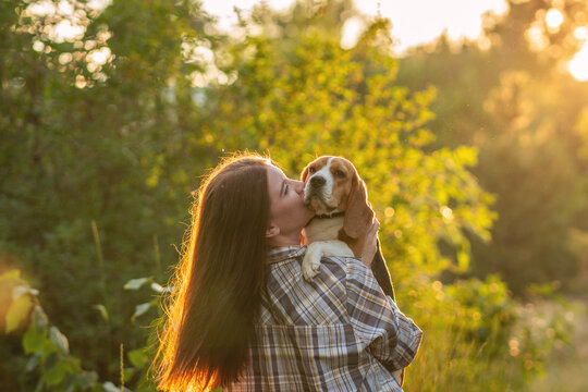 Woman Kissing Beagle During Golden Hour Portrait