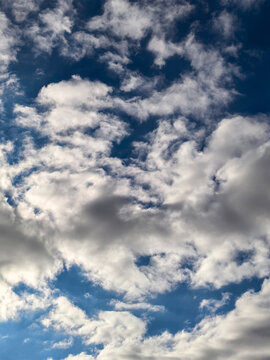 Textured White and Gray Clouds Filling Deep Blue Sky