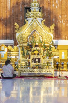 Altar for offerings to Buddha, Dharma and Sangha, in front of the chedi at Wat Phra That Phanom, temple complex in Amphoe That Phanom, Nakhon Phanom Province, Isan, Thailand