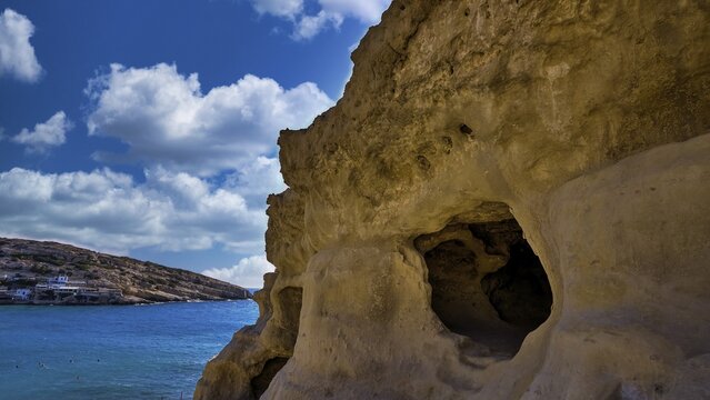 Sky changed, Neolithic caves, former hippie paradise, rock formations with large caves, view of the sea under blue sky and clouds, Matala, south coast, Crete, Greek islands, Greece